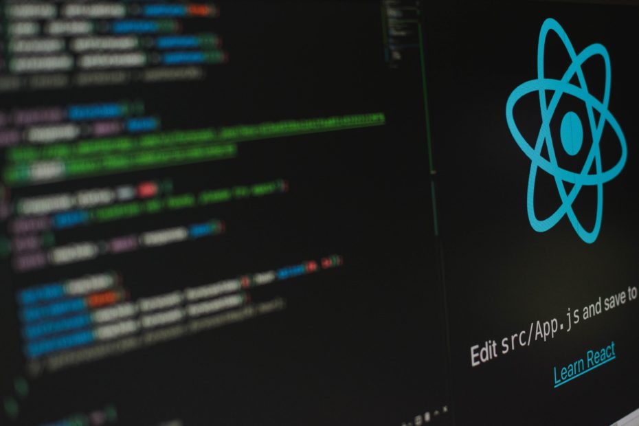 A computer screen with an IDE and a React js logo on it photo